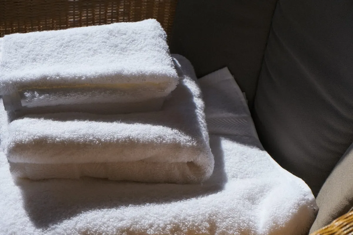 Folded white towels resting in soft afternoon light
